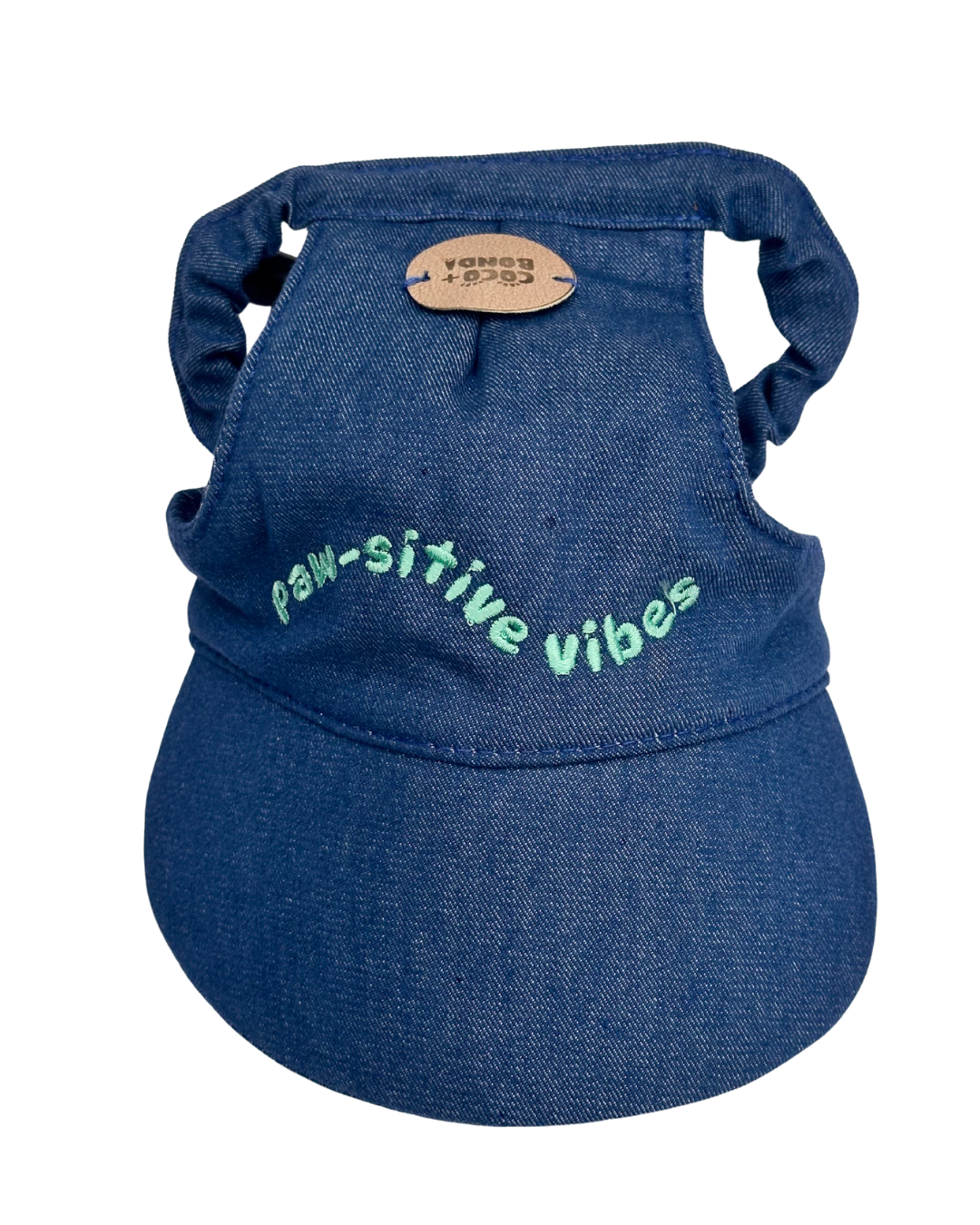 Blue denim dog harness with 'paw-sitive vibes' text on a white background